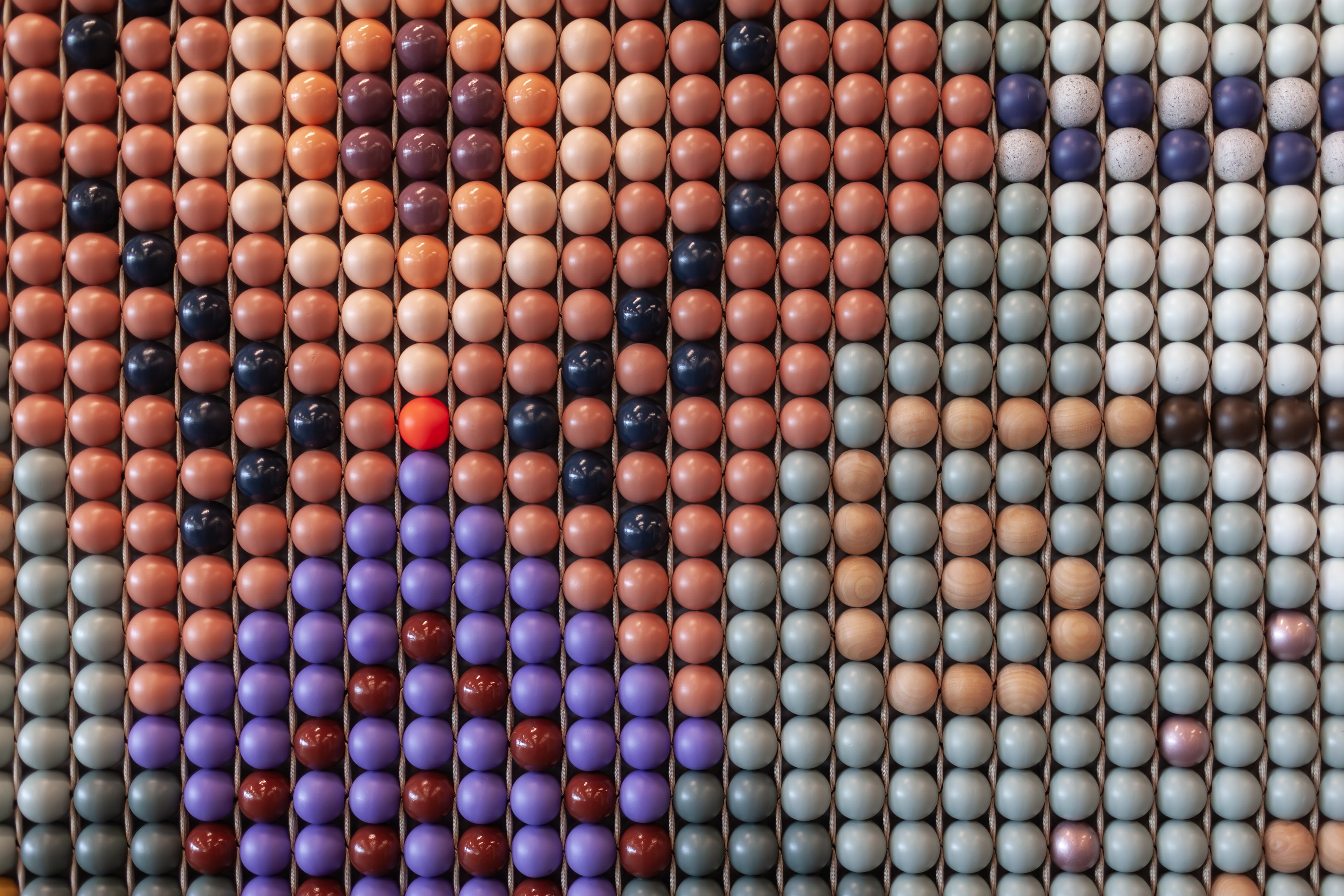 The finished weave: painted beads in coral, violet, sage and natural wood